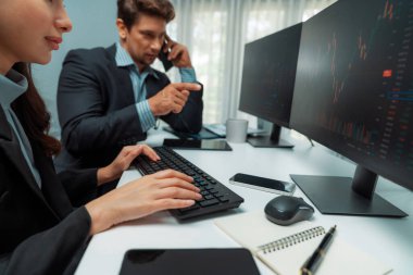 Borsacı bir adam, borsada yüksek kâr elde etme noktasını dijital para birimiyle bildirmek için tüccar işadamını ararken, bir kadın da gerçek zamanlı olarak veri monitörünü incelemeye başladı. Varsayım.