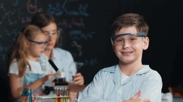 Smart Boy Crossing Arms While Teacher Friend Doing Experiment Stem — Stock Video