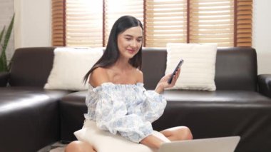 Genç bir kadın internet bankacılığı için kredi kartıyla dizüstü bilgisayar kullanıyor. Evinde online ödeme kapısı ile E ticareti yapıyor. Banka kartıyla modern ve kullanışlı online satın alma. Blithe