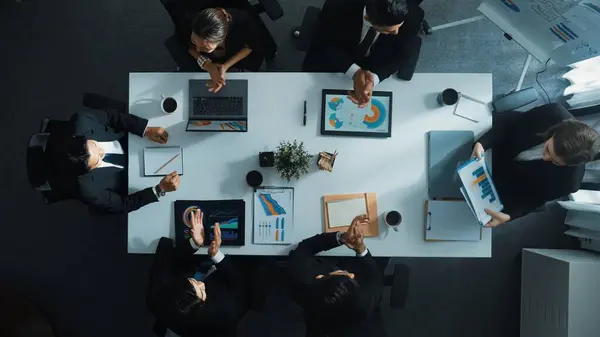 stock image Time lapse of diverse marketing team prepare for business meeting. Top down aerial view of businesspeople placed laptop and tablet with financial statistic at table. Creative business. Directorate.