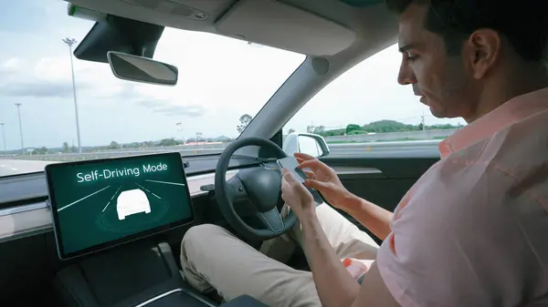 Self driving car or autonomous vehicle travel on speed highway with driverless system and autopilot mode allowing man driver relax and focus on smartphone without compromising safety. Perpetual