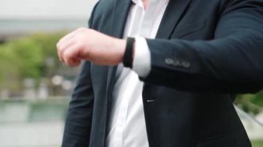 İş adamının önemli bir randevuya ya da toplantıya zamanında gelip gelmediğini kontrol et. Saate bakıp iş arkadaşını ya da iş arkadaşını beklerken aceleyle müdürlük yapıyor. Yaşam tarzı. Urbane.