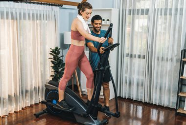 Atletik ve sportif genç çift ya da koşan makineyle koşan spor eşi, evde spor olarak vücut egzersizi yapmak. Gaiety evde egzersiz eğitimi.