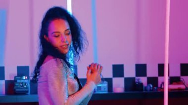 Stüdyoda mor ışıkla sokak dansı yapan İspanyol sokak dansçılarına yakın çekim. Profesyonel sanatçı şık kumaşla enerjik bir hareket sergiler. Çılgın, komik. Yarı vücut. Mutluluk.