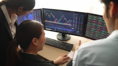 Hisse senedi borsası pazarlamasını analiz eden yavaş çekim şirketindeki yatırımcılar, kayıp için mum bar fiyatını analiz eden monitörlere bakıyor ve kazanç ve kâr elde ediyor. Filizlenen