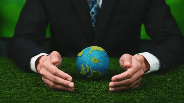 stock image Businessman holding planet Earth globe symbolize eco-friendly business commitment to environmental protection and zero carbon emission. Earth World Day concept to promote eco awareness. Gyre