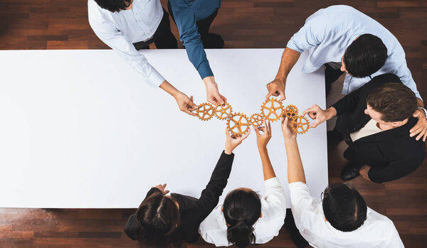 Top panorama banner of business team joining cogwheel in circular together symbolize successful group of business partnership and collective teamwork in workplace with productive efficiency. Prudent