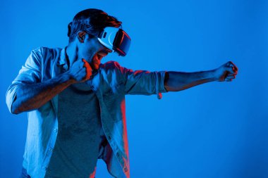 VR cam takan, kameraya vuran ya da yumruk atan bir adamın yan görüntüsü. Profesyonel sporcu boks ve metaevren ya da sanal dünyada teknoloji yeniliklerini kullanırken hareketli jest. Sapma.