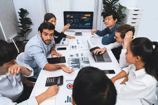 stock image Analyst team utilizing BI Fintech to analyze financial data at table in meeting room. Businesspeople analyzing BI dashboard power for business insight and strategic marketing planning. Prudent