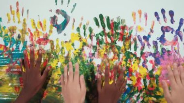 Rengarenk duvarlara yerleştirilmiş mutlu öğrenci eli. Çok kültürlü el ya da karışık ırk çocukları resim odasında el izlerini boyarlar. Geçmişi. Yaratıcı aktivite. Öğretim
