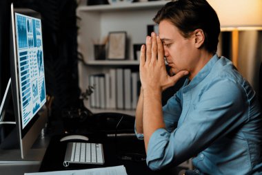 Dinamik veritabanı pazarlama analizi ile PC ekranındaki iş paragrafını araştıran stresli finansal analistin gece vakti modern ev ofisinde aylık rapor hazırlamasını düşünüyorum. Bireysel.