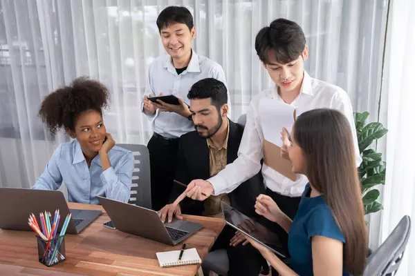 stock image Happy diverse business people work together, discussing in corporate office. Professional and diversity teamwork discuss business plan on desk with laptop. Modern multicultural office worker. Concord