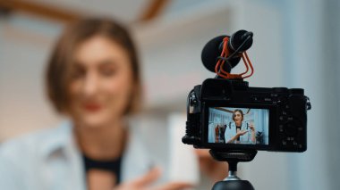 Arka görünüm, kamera ekranında kadın nüfuzunu gizler. Video görüntüleme, video görüntüleme, giysi, sosyal medya ya da blog. Canlı yayın için stüdyo ışıklandırması olan bir kız.