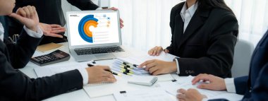 İş istihbarat analisti ekibi bilgisayardaki BI yazılımını kullanarak finansal veri gösterge panelini analiz ediyor. İş teknolojisi, şirket yöneticilerini panoramada stratejik kararlar vermeye teşvik ediyor. Kurnaz.