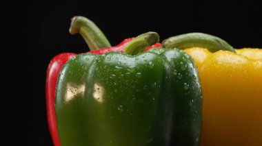 Macro of fresh bell peppers in this stunning macrography against a black background. Each close-up shot captures the rich hues, intricate textures, and captivating details of bell peppers. Comestible. clipart