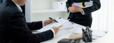 Kurumsal muhasebeci ekibi vergi iadelerini hesaplamak ve en yüksek seviyeye çıkarmak için hesap makinesi kullanır ve finansal veri raporuna dayanarak finansal performansı artırır. Panorama 'daki modern muhasebe. Kurnaz.