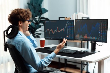 Başarılı genç yatırımcı, akıllı telefondan iş ortağına Dinamik Finansal Değişim Yatırım Dizüstü bilgisayarı ile modern ofisteki mevcut pazar grafiğinde gerçek zamanlı arıyor. Toplayıcı.