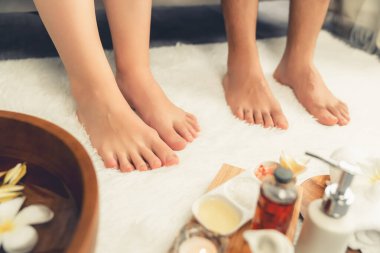 Lüks spa salonlarında refleksoloji terapisi için gün ışığı atmosfer tesisinde ya da otel ayak spa 'sında keyifli ayak masajı yapan bir çift. Sessiz.