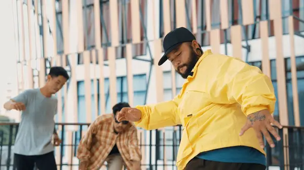 Stock image Hip hop team dance break dance while multicultural friend surrounded and clapping hands to cheer or encourage his friend to dance. Active and energetic street dance. Outdoor sport 2024. Endeavor.