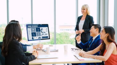 Human resources management software on computer screen helping human resources employee to manage recruitment, payroll, staff searching and KPI evaluation snugly