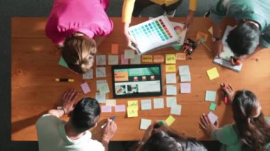 Web tasarımı için birlikte çalışan iş adamlarının üst düzey görüşü. Tasarımcı beyin fırtınası yapan ve web sitesi arayüzü hakkında tartışan ve dijital tasarım ile tablete bakan hava görüşü. Sempozyum.