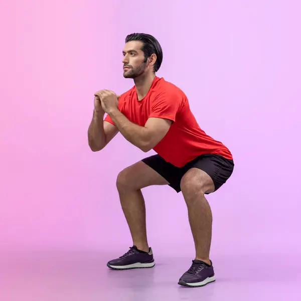 stock image Full body length gaiety shot athletic and sporty young man with fitness in squat exercise posture on isolated background. Healthy active and body care lifestyle.