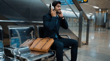 Tren istasyonunda oturmuş müzik dinleyen yetenekli bir iş adamı. Profesyonel Kafkas proje yöneticisi tren ya da metro bekliyor. Erkek lider dinlemekten hoşlanır. Takım elbiseli rahat müzik. Sevinçli..