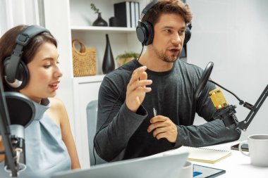 Birlikte tartışan sunucu kanal yayıncıları, dinleyicilerle canlı yayında sorun için tavsiyelerde bulunuyorlar. Rahat modern işyerindeki radyo sohbet programında canlı yayının etrafını sardılar. Varsayım.