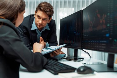 Kağıt raporunda değer istatistik şirketini tartışan iki tüccar dinamik borsa para birimini gerçek zamanlı web sitesi ofisteki bilgisayar ekranlarını çevreledi. Varsayım.