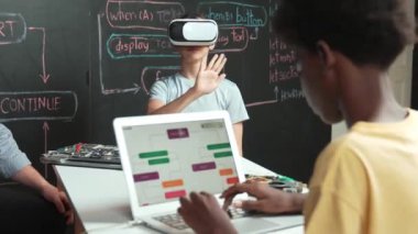 Afrikalı erkek programlama sistemi, beyaz bir kız karatahtanın başında mühendislik kodlarıyla otururken metaverse 'e giriyor. Liseli kız STEM teknolojisinde VR ya da kulaklık takıyor. Öğretim
