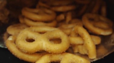 Dağılmış tuzlu krakeri bir paketin içinde saklayın. Hareket eden kamerayla yerleştirilmiş makro atıştırmalık. Stüdyo makro atıştırmalık ve baharat tozu. Tasarım ve baskı için alanı kopyala. Pabulum.