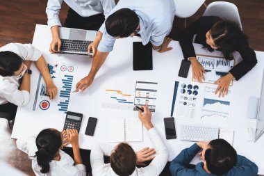 Üst görünüm proje yöneticisi proje yönetimi yazılımı kullanarak ekip ile iletişim kurar ve işbirliği yapar, proje görevinin ilerlemesini izler ve toplantı masasında program planı yapar. Tedbirli