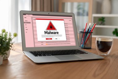Cyber attacking concept. Malware alert showing on computer screen display scam and threat detection on computer system or online server to be removed snugly.