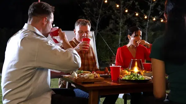 stock image Family gather celebrate holiday. Focus father, grandmother and grandfather talk and have dinner party food. Outdoor activity for spending time with polite relatives strengthen family bond. Divergence.