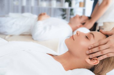 Kafkasyalı çift stres önleyici kafa masajının keyfini çıkarıyor ve lüks otellerde ya da otel spa salonlarında gündüz kaplıcalarında yüz güzelliği eğlencelerini şımartıyor. Sessiz.