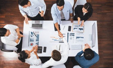 Üst düzey ofis çalışanları stratejik iş pazarlama toplantısı üzerine anlaşma yaptıktan sonra el sıkışıyor. Takım çalışması ve olumlu tutum verimli ve destekleyici bir iş yeri yaratır. Tedbirli
