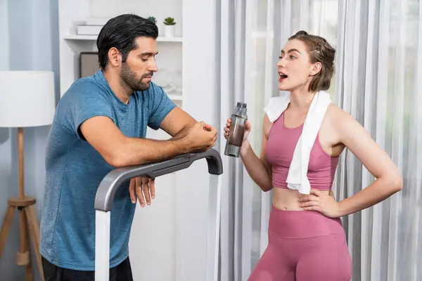 stock image Athletic body and sporty young couple or workout buddy in sportswear warmup or resting after finishing in home workout exercise at gaiety home exercise and healthy lifestyle concept.