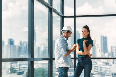 Professional smart architect engineer team discuss and solve building construction problems. Engineer taking a note while listening manager sharing idea about work surrounded by skyscraper. Tracery. clipart