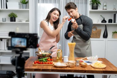 Birkaç aşçı spagetti, et, biber, domates, sarımsak ve baharat sosunu sunan yemek şovu malzemelerini canlı yayında canlı yayında kameraya kaydediyor. Varsayım.