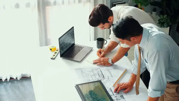 stock image Top view of professional architect engineer team writing sticky notes and sticking note at meeting table while interior designer talking and discussing about building exterior designing. Alimentation.