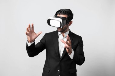 Takım elbiseli zeki bir iş adamı metaevreni bağlamak için sanal gerçeklik gözlüğü takıyor. Profesyonel proje yöneticisi görsel gerçeklik kulaklığı kullanarak holograma bakıyor. Teknoloji yeniliği. Sapma.