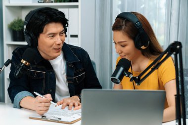 Gülümseyen radyo etkili sunucular, kulaklık takarak sosyal medya kanalından canlı yayın yapıyorlar ve sabah saatlerinde stüdyo kaydında dinleyicilere konu ve dizüstü bilgisayar üzerinden konuşuyorlar. İnfobahn.