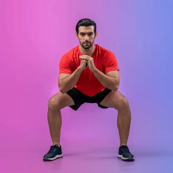 stock image Full body length gaiety shot athletic and sporty young man with fitness in squat exercise posture on isolated background. Healthy active and body care lifestyle.