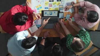 Akıllı yaratıcı proje yöneticisinin cep telefonu arayüzü için dizüstü bilgisayarı kullanırken pazarlama ekibinin beyin fırtınası zihin haritası kullanarak yazılım programı tasarladığına dair üst görünüm. Cemaat.