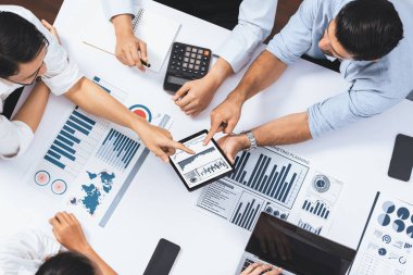 Üst düzey analist ekibi toplantı odasındaki mali verileri analiz etmek için BI Fintech 'i kullanıyor. İş anlayışı ve stratejik pazarlama planlaması için kağıt üzerinde analitik BI gösterge paneli. Tedbirli