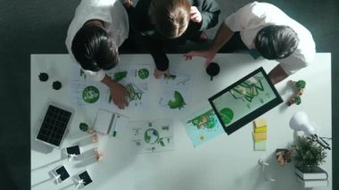 Yönetici tutma tabletinin üst görünümü toplantıda temiz enerji yatırımını gösteriyor. Yetenekli iş adamlarının birlikte çalıştığı ve sürdürülebilirlik çevre enerjisini kullanmayı planladıkları hava görüşü. Hizalama.