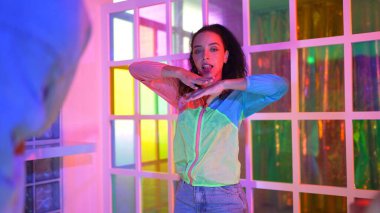 Break dansçı break dans yaparken gece kulübünde neon ışıklı bir arkadaş performansı sergiledi. Profesyonel hipster serbest stil müziğe geçiyor ve hareketli bir ruh hali içinde ayak izlerini gösteriyor. Yaşam tarzı. Mutluluk.