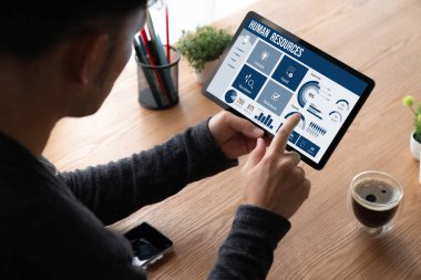 Human resources management software on computer screen helping human resources employee to manage recruitment, payroll, staff searching and KPI evaluation snugly