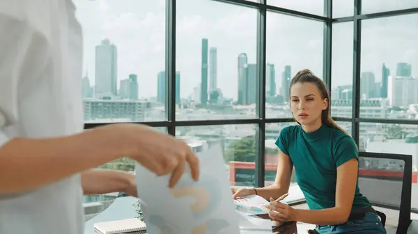 stock image Professional female investor listening businessman present start up project statistic. Back view of businessman shows graph while manager using laptop analysis data at cityscape view. Tracery