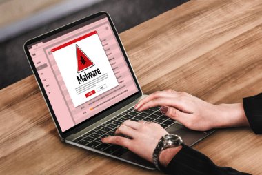 Cyber attacking concept. Malware alert showing on computer screen display scam and threat detection on computer system or online server to be removed snugly.